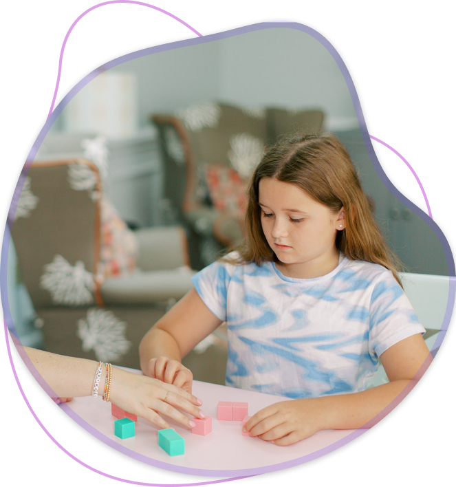 Girl & therapist playing with blocks